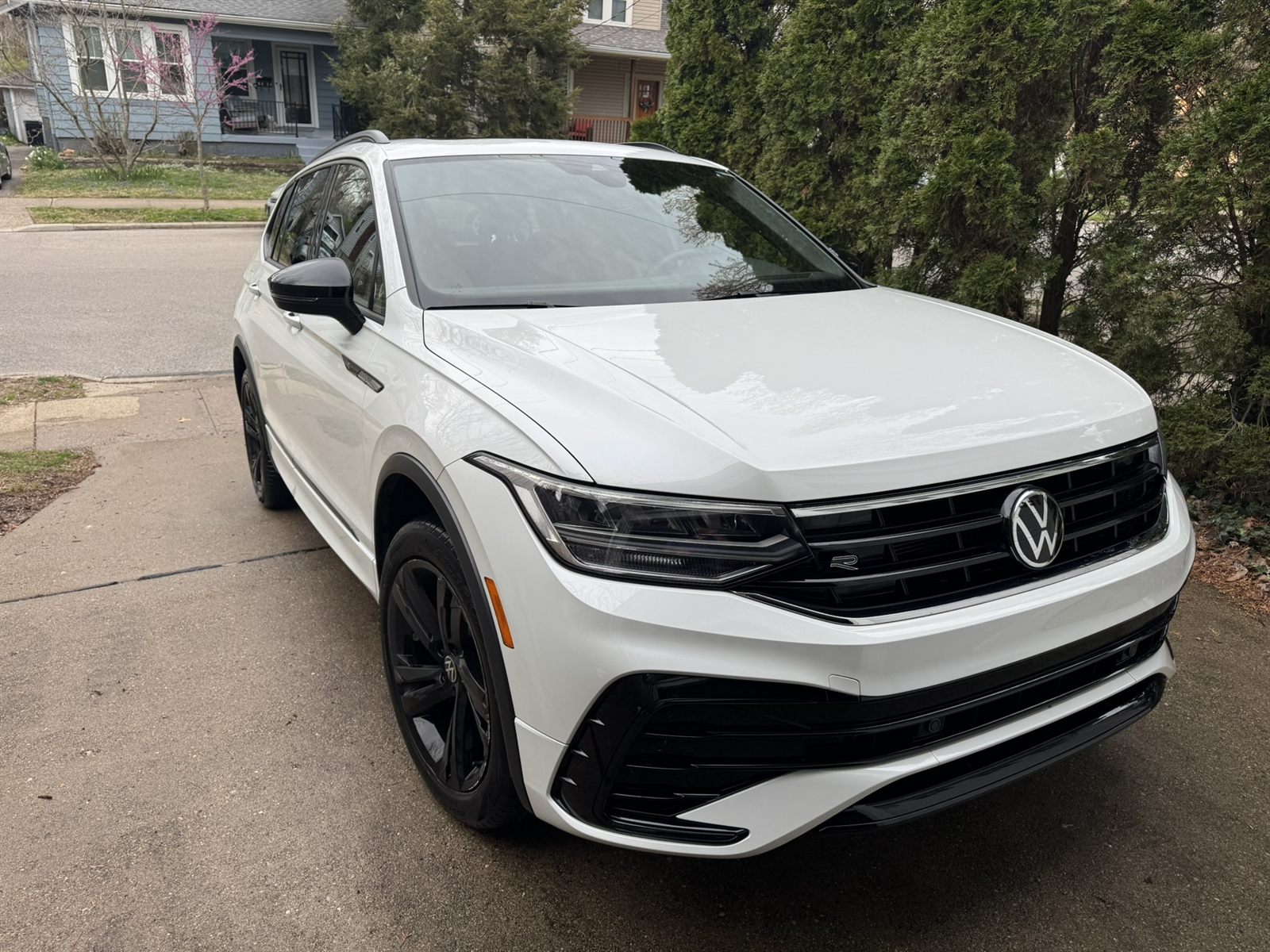 Freshly detailed glossy white SUV in a Cincinnati driveway